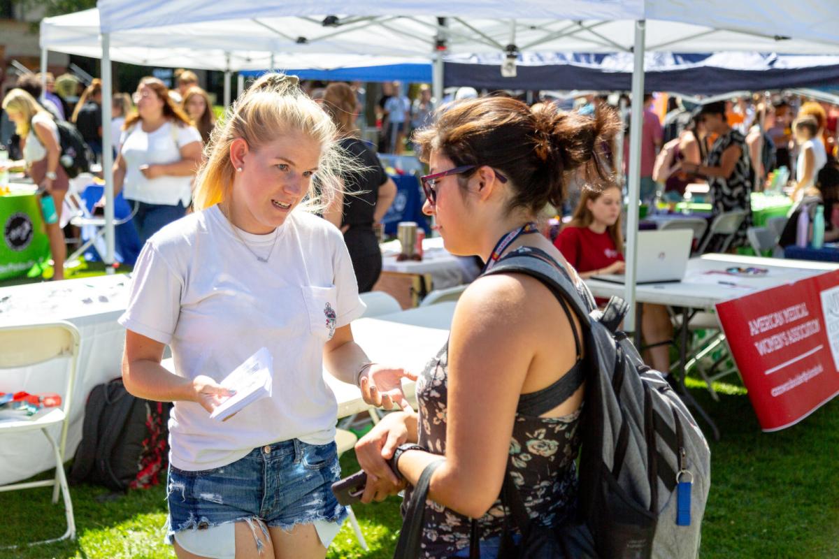 two students talking to each other outside