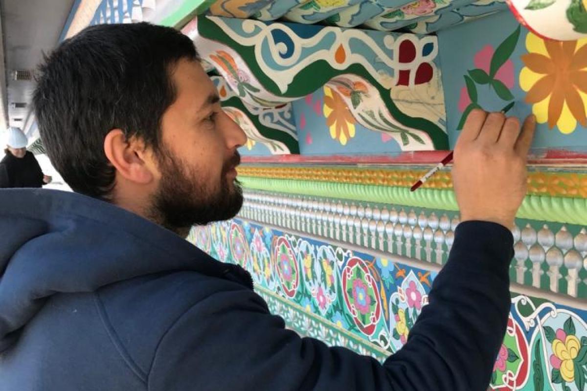 Artist restoring the Boulder Dushanbe Teahouse.