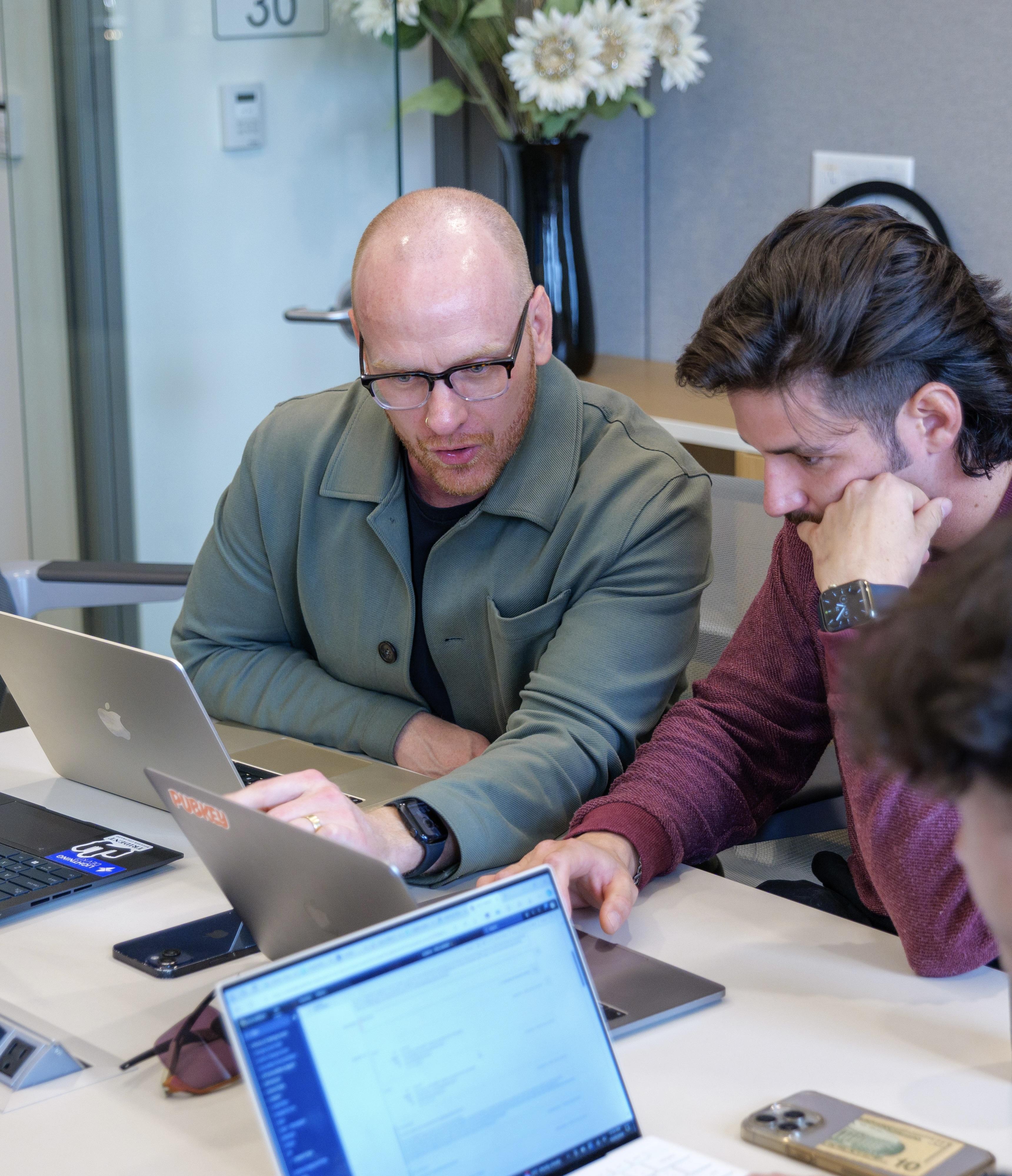 Photo of Clinic Members discussing at Laptops