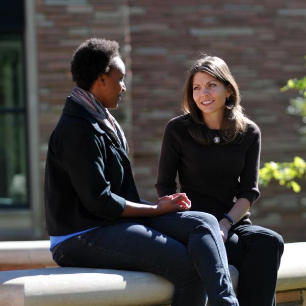 Two females sitting and talking