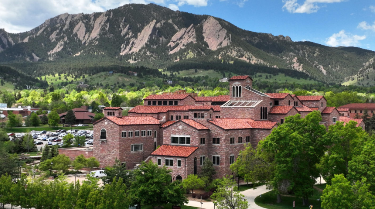 Arial view of CU boulder campus with flat iron mountains in background