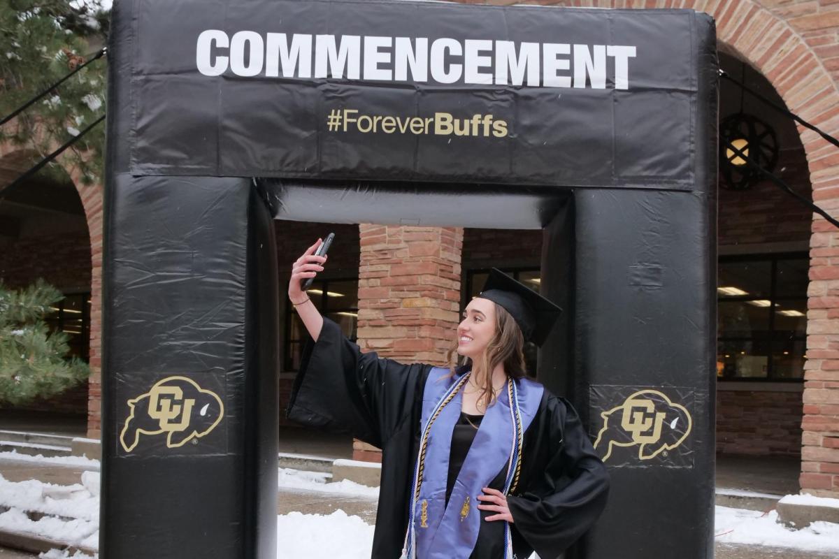 A student taking a selfie at one of the on-campus photo opportunity locations