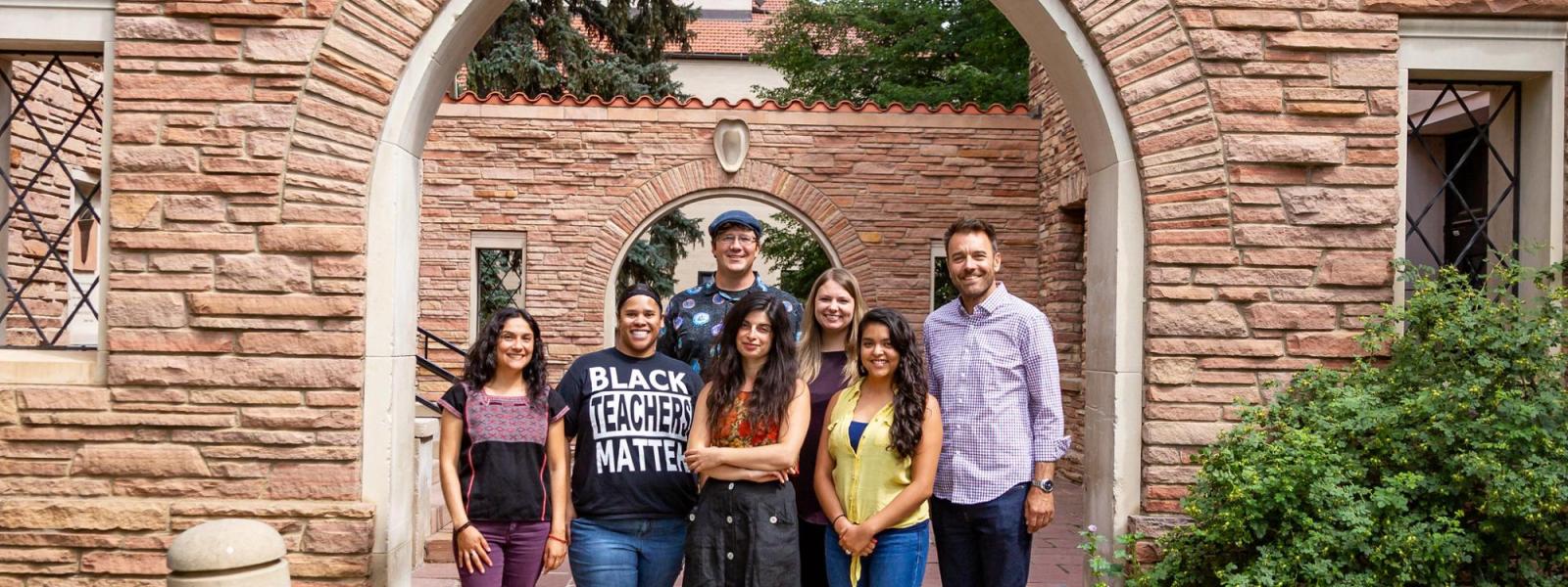 Graduate Fellows posed in archway