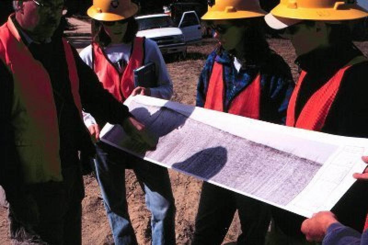 Teacher and students studying geologic data