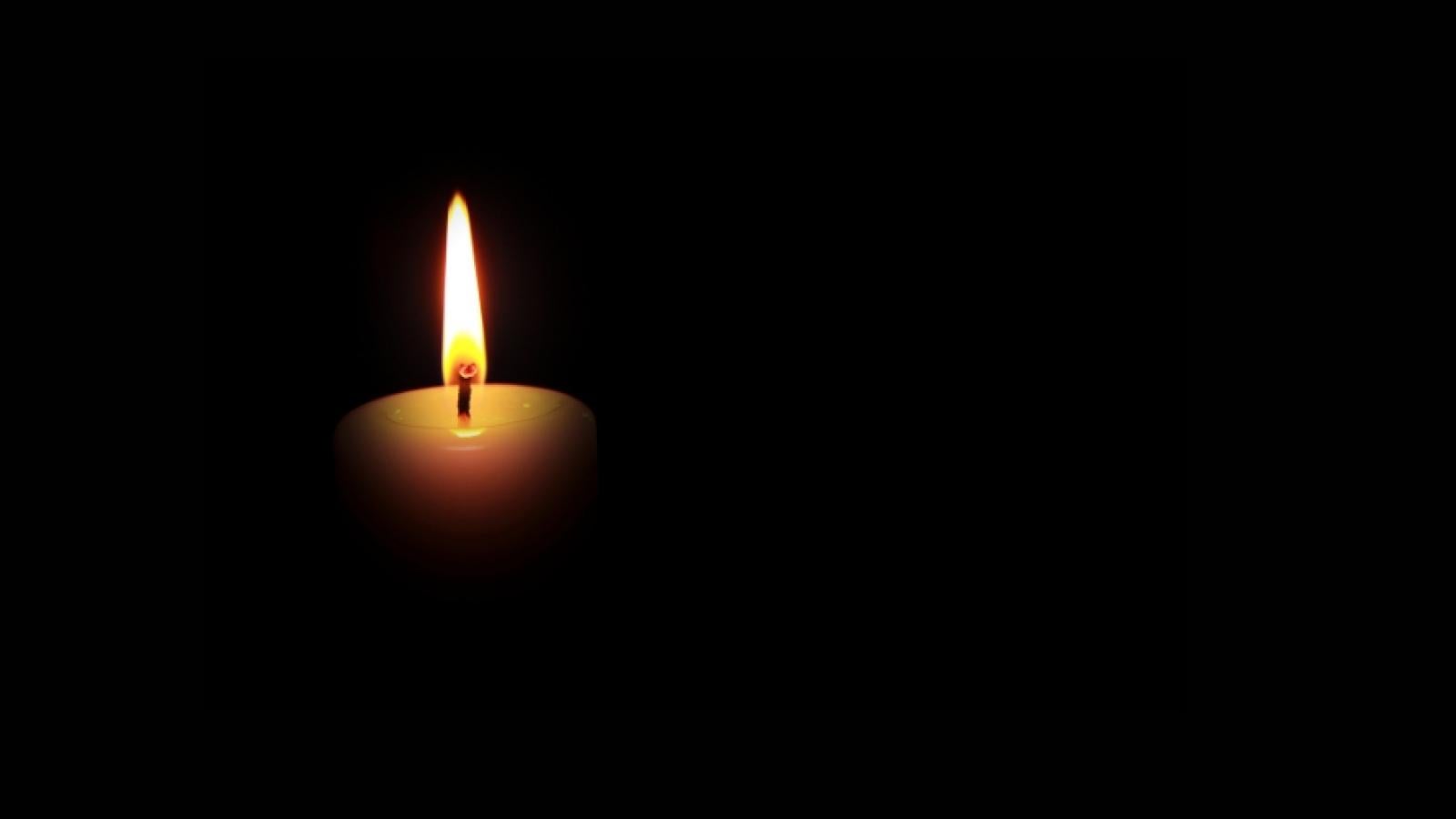 Candle on black background