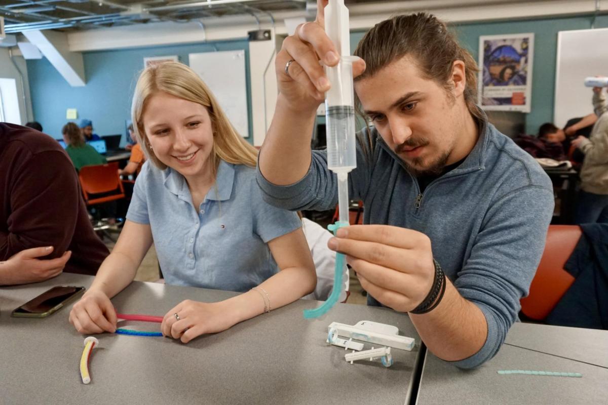 A male and female student working on their senior design project.