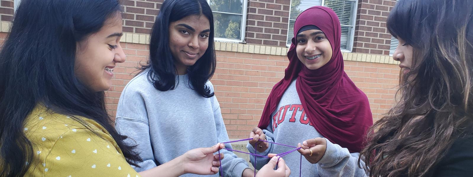 4 girls holding a string
