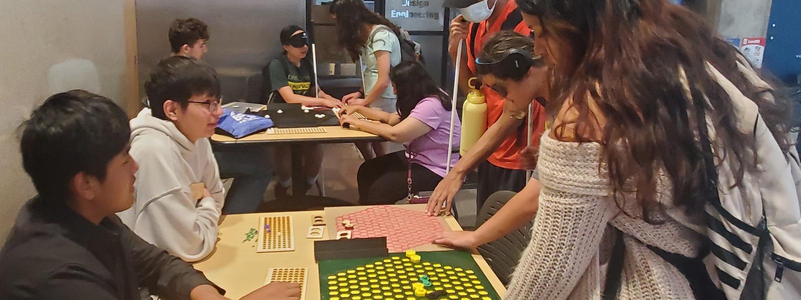 People grouped around a board game