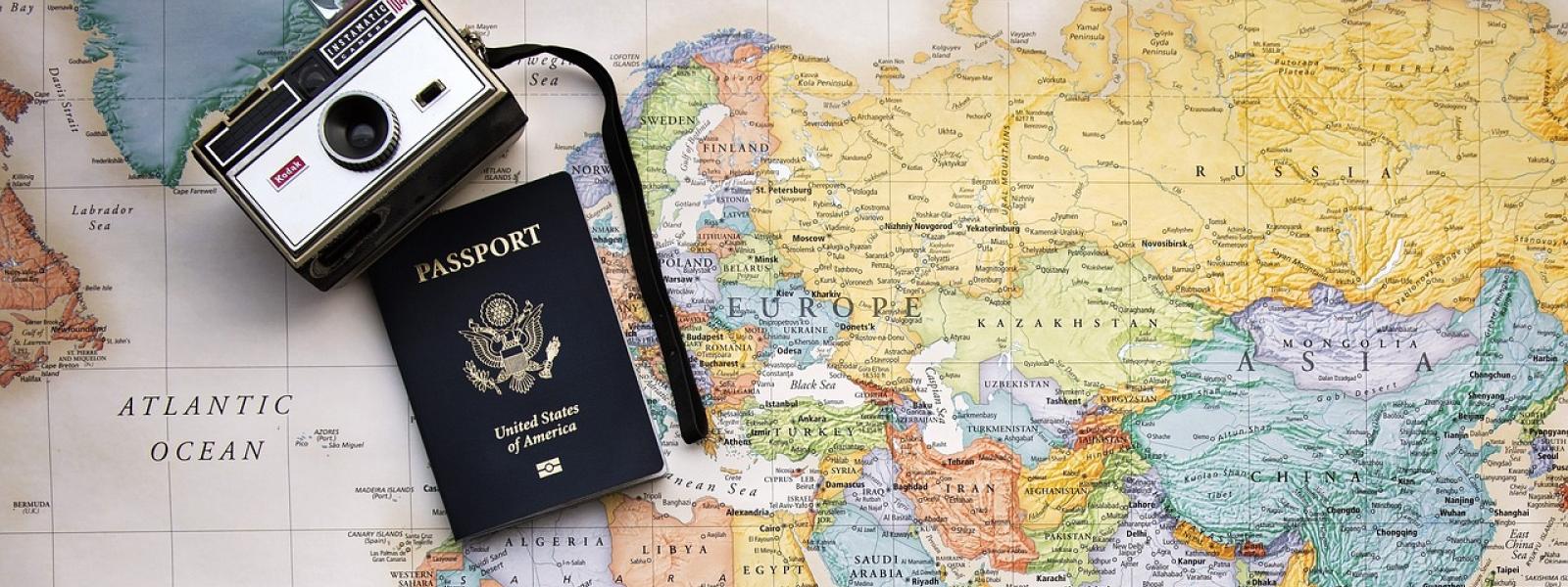 Passport and camera on world map