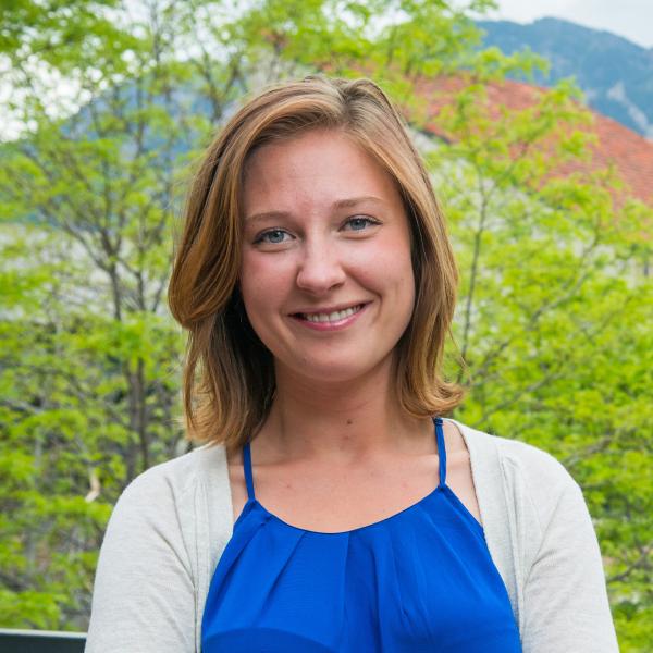 Nicole Ela outside the Engineering Center with the Flatirons in the background.