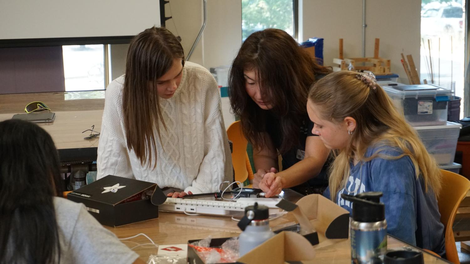 Prof. Matsuo helping two camp attendees with their camera.