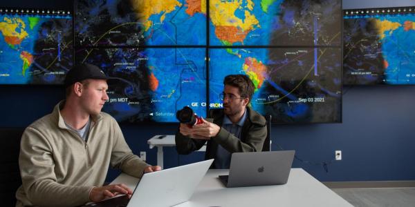 Graduate students Michael Klonowski, left, and Daniel Aguilar-Marsillach, right, work in the Raytheon Space & Intelligence Vision, Autonomy, and Decision Research Lab at CU Boulder, which studies new methods for tracking and managing satellite traffic in space.
