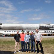Members of the science and implementation team at Kennedy Space Center with a space-proven Falcon 9 rocket on the background. From left to right: Eric Yarns (KU), Kevin Ngo (KU), Luis Zea (CU Boulder), Dr. Joe Tash (KU), and Sam Piper (CU Boulder)