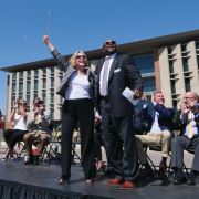 Drones lift a ‘Cut Before Flight’ ribbon to Ann Smead (left) and Brian Argrow at the Aerospace Engineering Sciences Building grand opening ceremony on August 26, 2019.