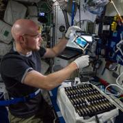 ESA astronaut Alex Gerst working with a Bioserve Drug Metabolism experiment.