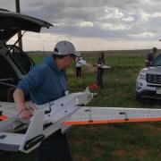 Engineers from CU Boulder get ready to deploy a RAAVEN drone during a storm. (Credit: IRISS)