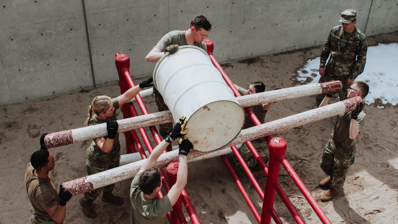 Cadets rolling a barrel in an LRC