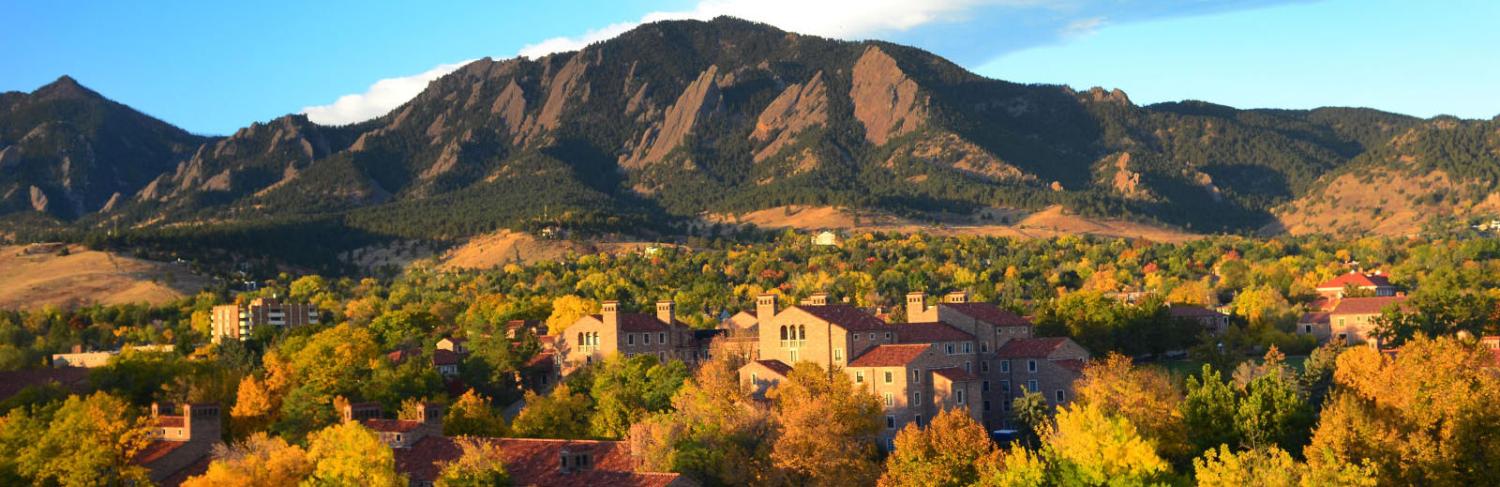 Campus and the Flatirons at sunset on a fall day