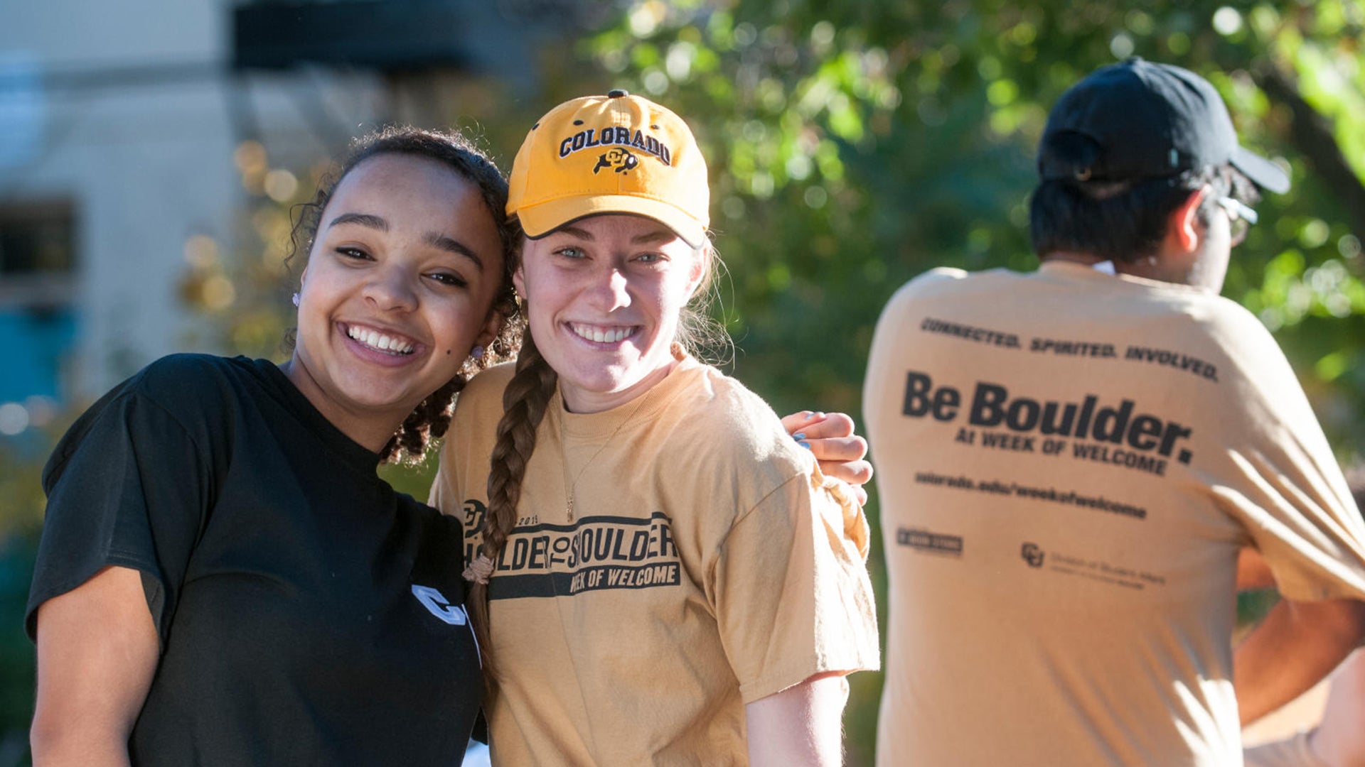 Two CU Boulder alumni hugging at a volunteer event