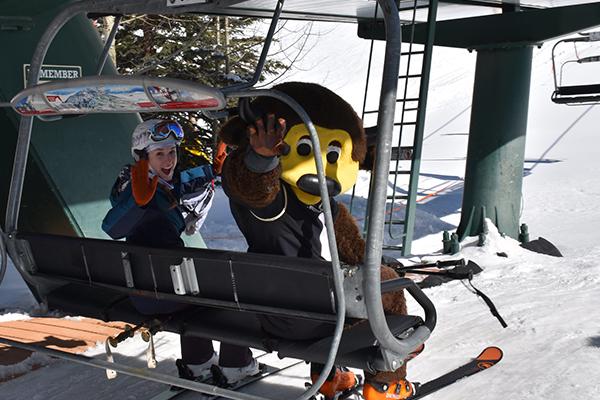 CU Alumnus and Chip wave from a ski lift
