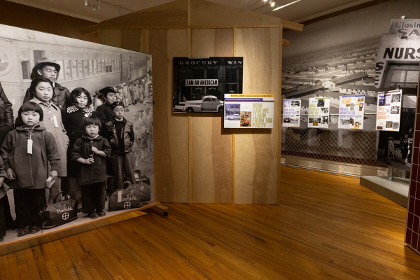 Museum panel showing WWII-era image of Japanese Americans 