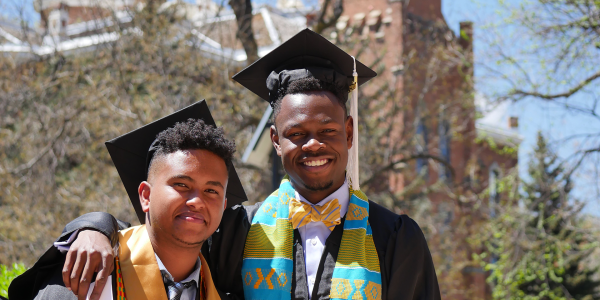 Two ForeverGold scholars in graduation regalia 