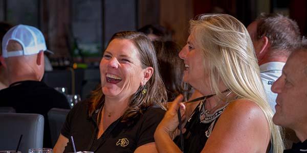 ForeverGold members laughing at an exclusive event