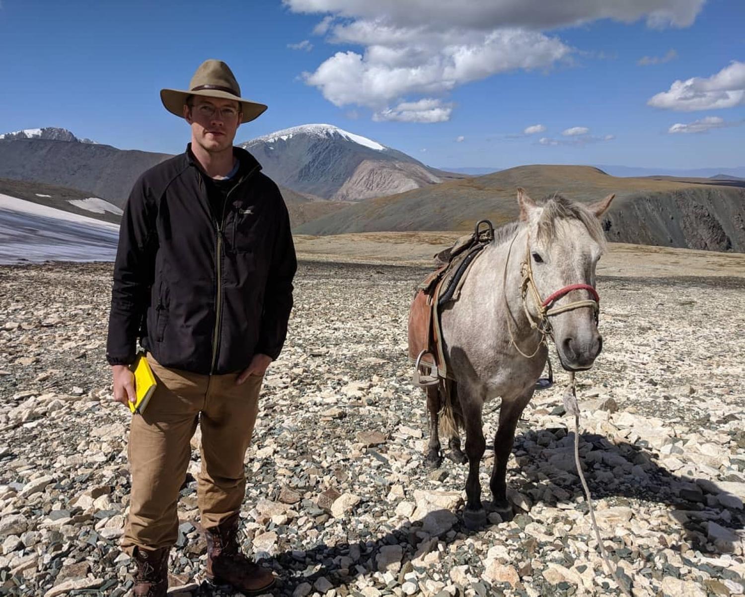 Will in the mountains with a horse