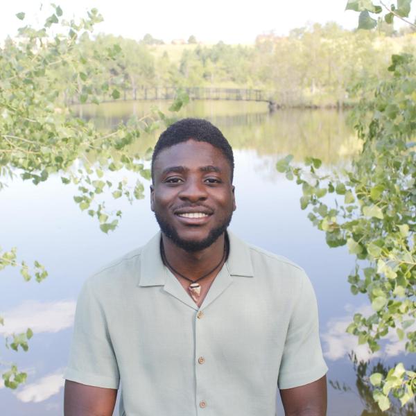 Olumide Ojediran in front of a pond