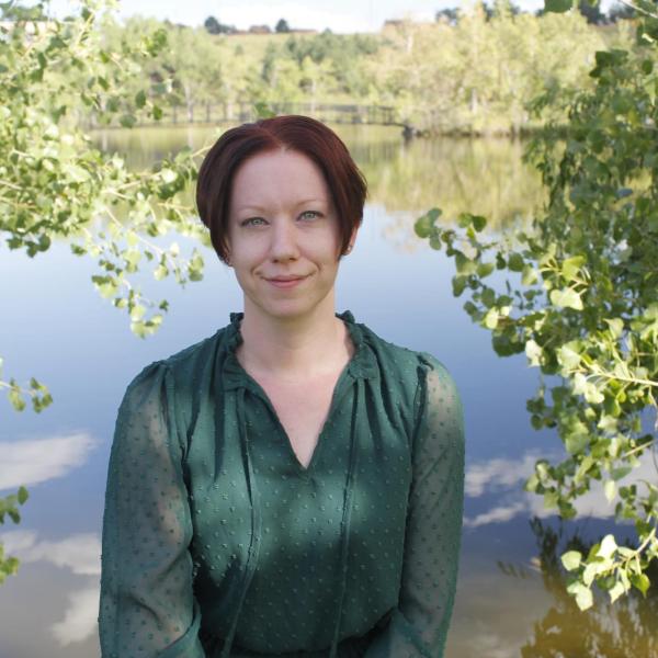 Robin James in front of a pond