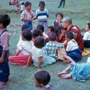 Dalai Lama sitting with Children
