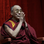 The Dalai Lama sitting with hands in prayer