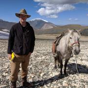Will in the mountains with a horse