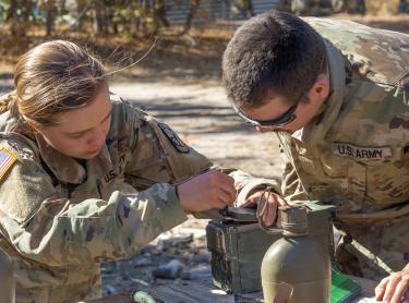 Cadets getting hands-on experience operating tactical radios. Photo courtesy of Cadet Arianna Decker.