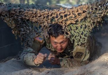 A Charlie Company Cadet works his way through the tunnel crawl section of the obstacle course. Photo courtesy of Cadet Arianna Decker.