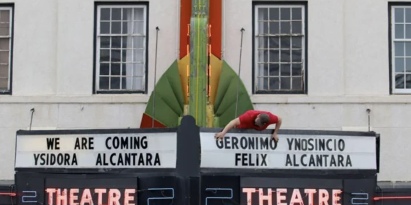Tyler Wilde installs the final letter on the marquee of the Cody Theater as part of the "We Are Coming" display Wednes Sept. 21, 2022. Stephen Dow