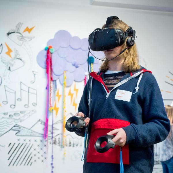 student with VR helmet