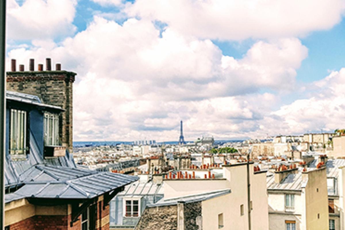 Photo from a study abroad trip shows the rooftops of Paris with the Eiffel Tower barely visible in the distance.