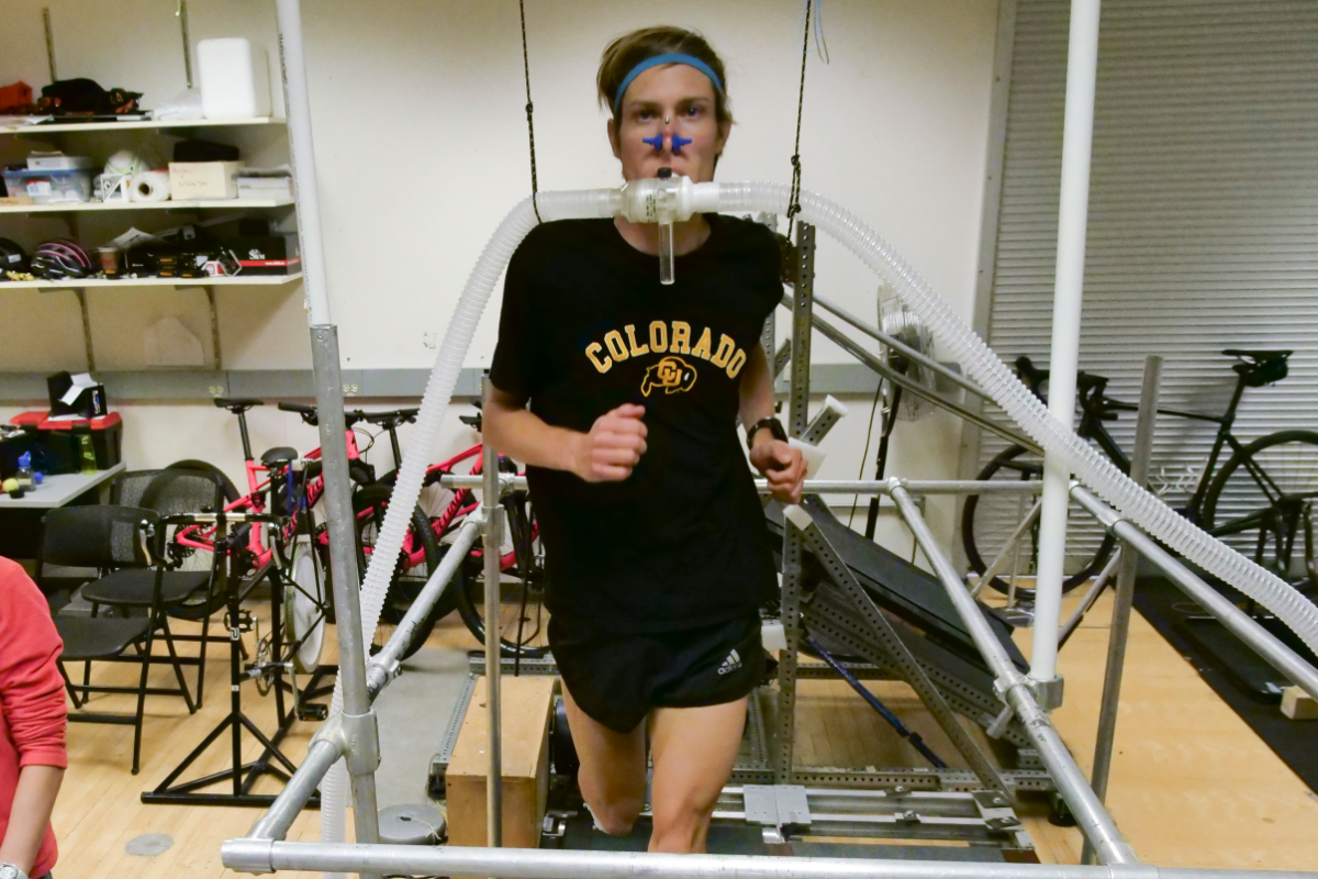 A student runs on a treadmill wearing a breathing mask that tracks his oxygen intake.