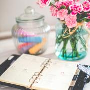 planner on a desk with flowers and chalk