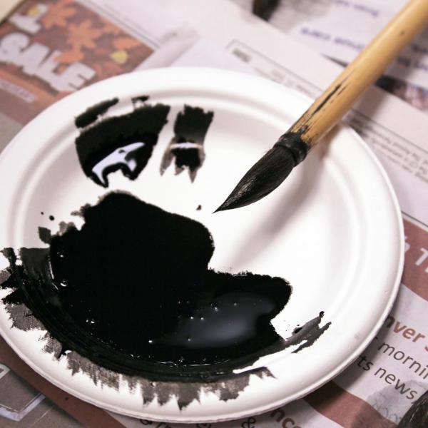 Pool of black ink and brush