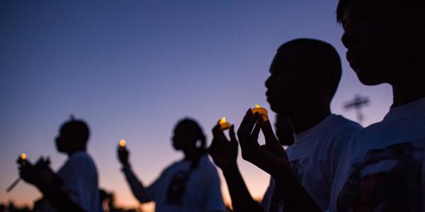 Students holding candles at the Mohammed Haitham memorial