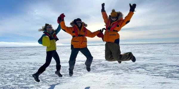 Cassandra Brooks, Ulyana Horodyskyj Peña and Zephyr Sylvester jumping in Antarctica