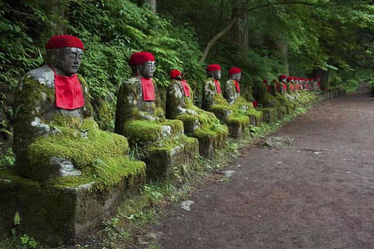 Jizo statues sit along the Daiya River and Jiunji Temple in Nikko, Japan. 