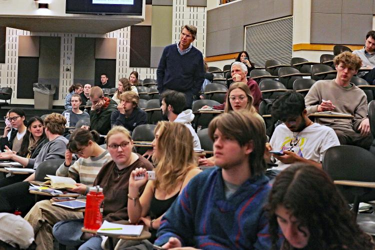 Paul Beale helps students in physics class