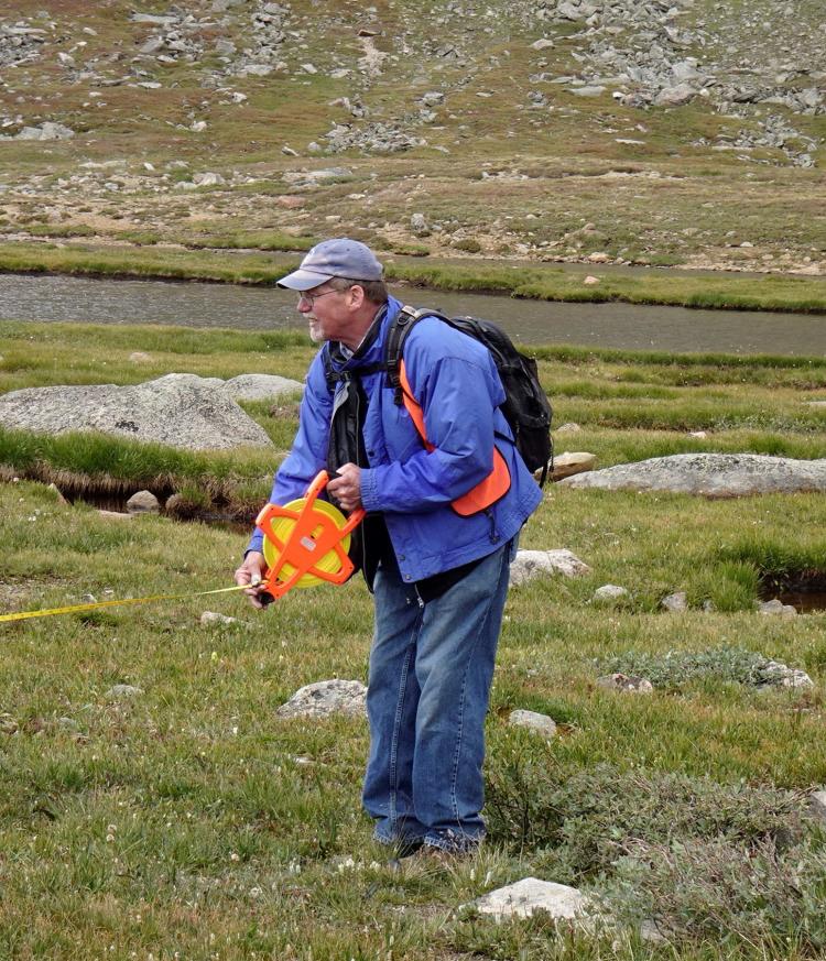 Laying out a vegetation monitoring plot for an alpine tundra restoration project at Summit Lake, CO.