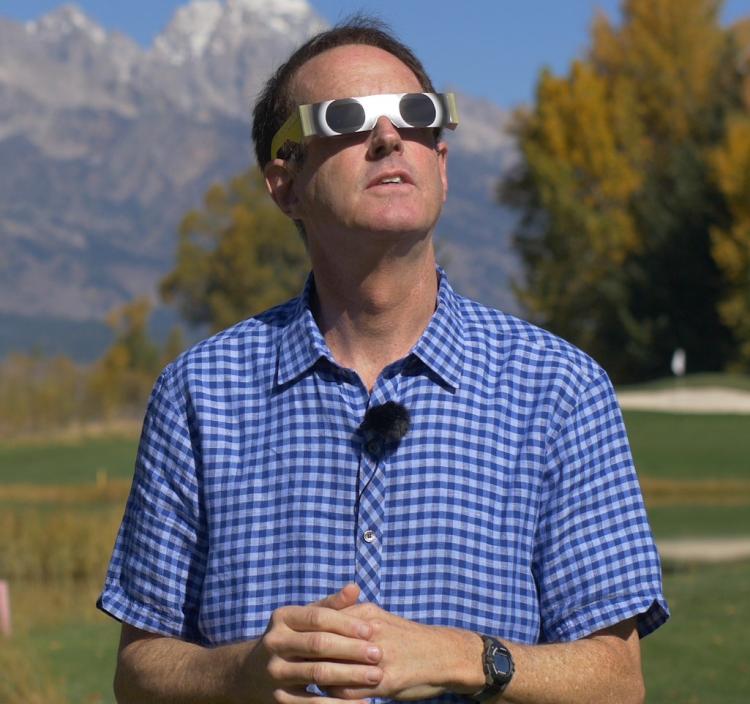 Doug Duncan using glasses to safely watch the solar eclipse