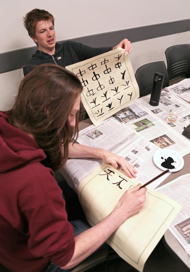 Students filling paper with Chinese calligraphy