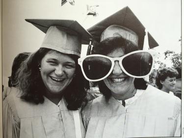 Janet Pollack poses with funny glasses on her graduation day in 1984. The woman on the left is Barb Keller Richard (Journ ’84).