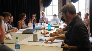 Geoffrey Kent leads a table reading of Douglas Langworthy's translation of Henry VI, Part 2. Photo by Jackson Xia for CU Presents.